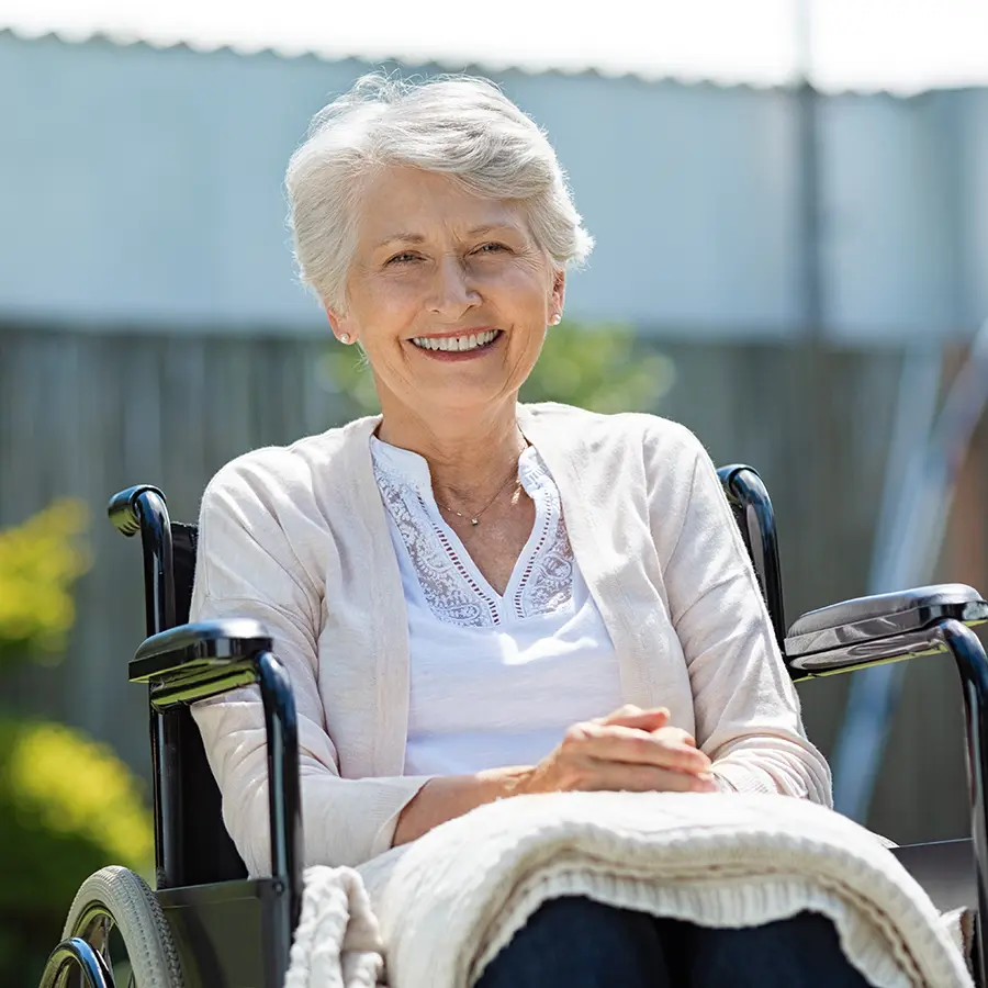 smiling woman sitting in a wheelchair